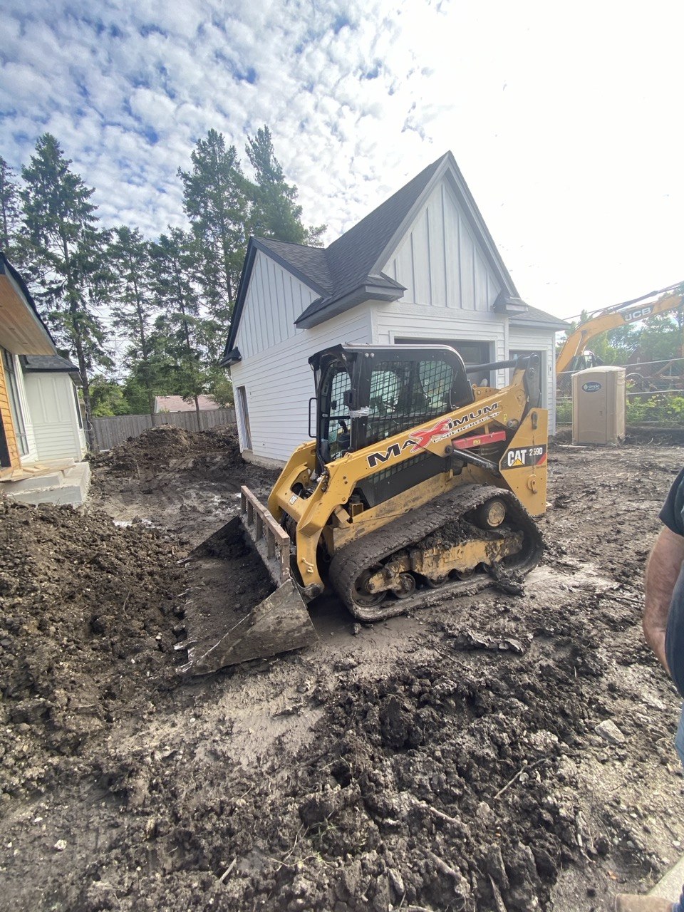 CAT skid steer with MAXIMUM branding grading